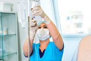 Healthcare Worker Preparing An Infusion Treatment