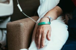 Patient with an IV line going into the arm