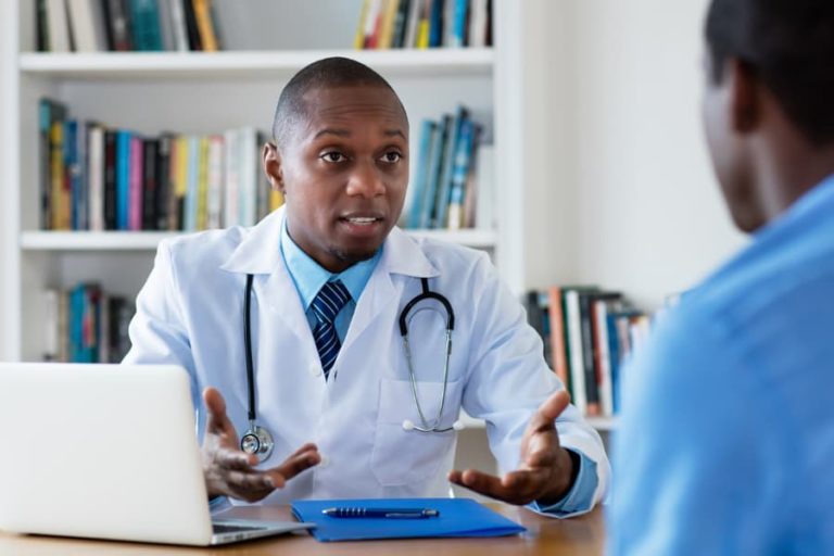 Oncologist discussing stomach cancer diagnosis with patient