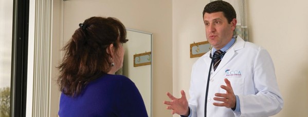 Oncologist explaining to a patient how cancer can affect the body