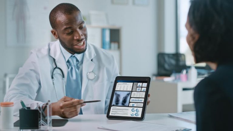 A doctor shows a patient a lung scan