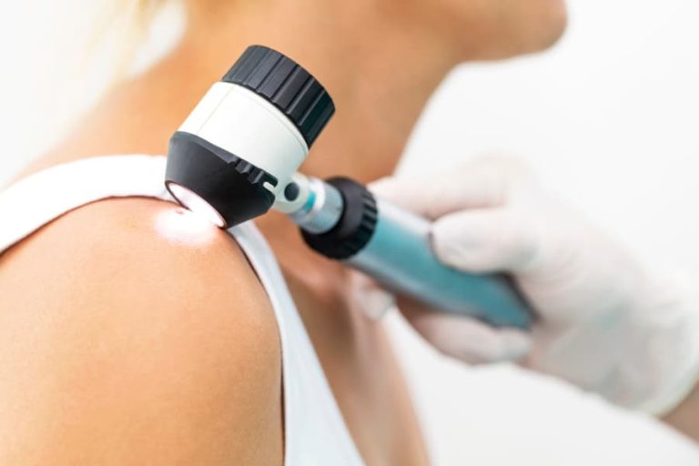 Medical professional holding light to a patient’s skin.