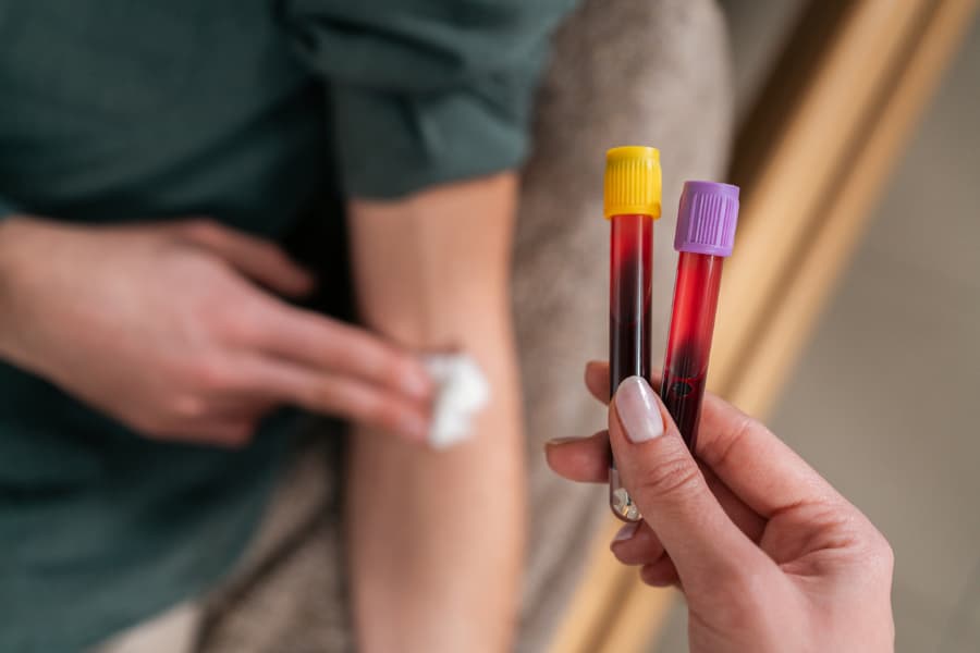 Healthcare professional collecting blood sample from patient