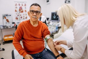 Doctor preparing patient for T-cell therapy