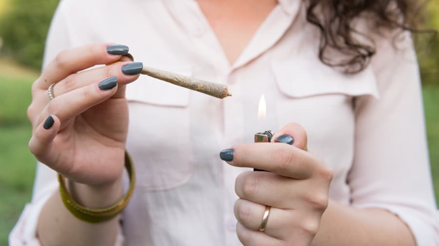 Young person smoking marijuana outdoors