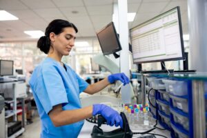 Hematologist organizing samples at station in laboratory