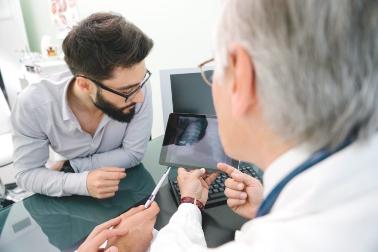 Oncologist discussing lung scan with patient