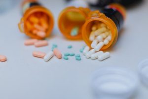 Open pill bottles spilling onto counter
