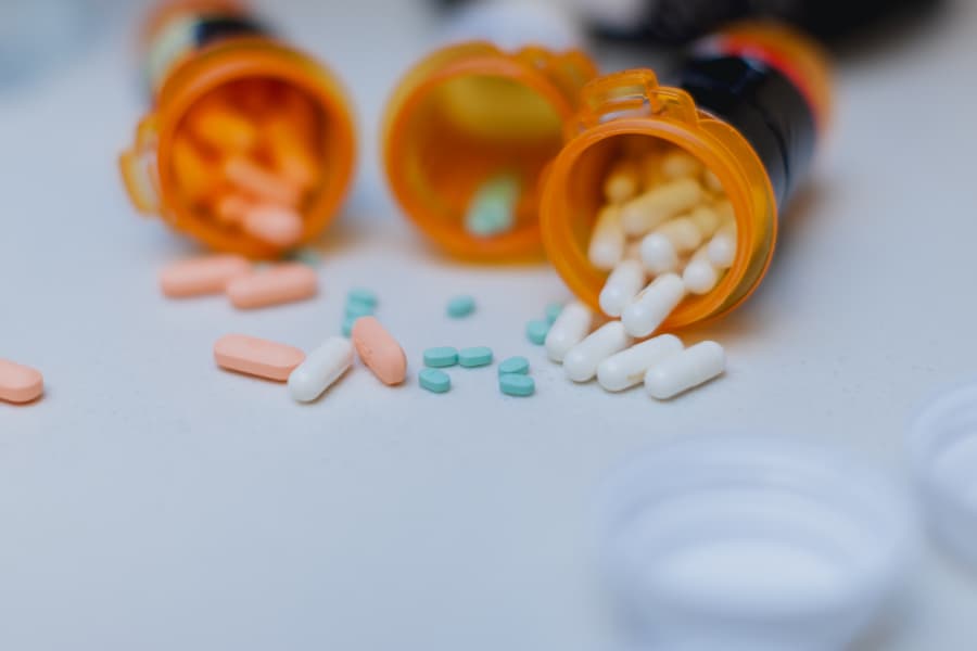Open pill bottles spilling onto counter