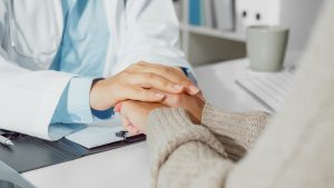 doctor holding hands with a Myelodysplastic Syndromes patient.