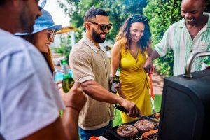 Group of friends and family grilling sausages