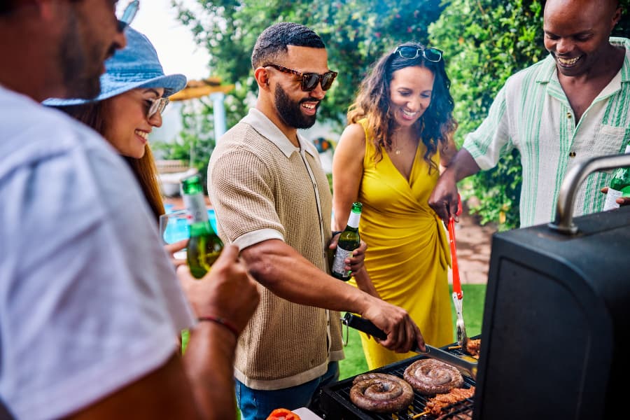 Group of friends and family grilling sausages