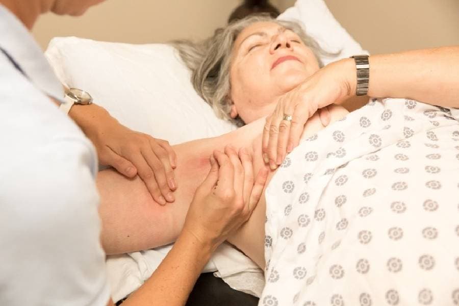 Patient receiving lymphedema massage on arm