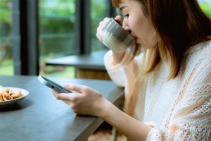 Woman reading the news on her phone
