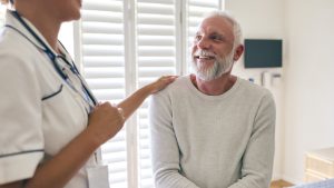 Nurse talks with patient with cancer