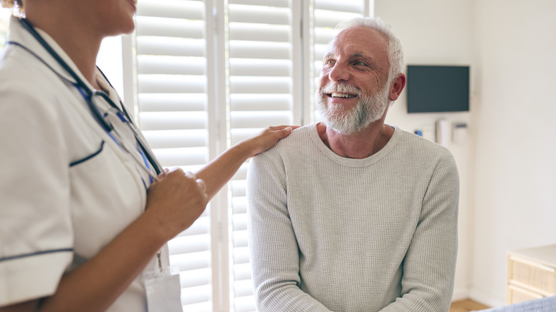 Nurse talks with patient with cancer