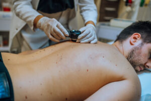 Dermatologist examines patient’s skin