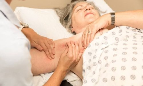 Patient receiving lymphedema massage on arm