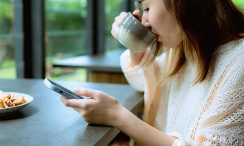 Woman reading the news on her phone